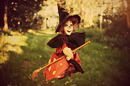 child with witch costume riding broomstick during daytime thumbnail