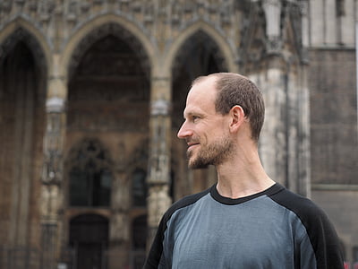man standing beside cathedral thumbnail