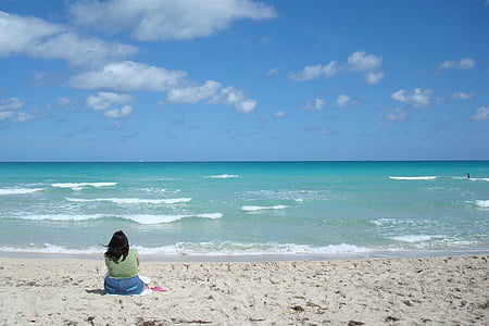 woman sitting on white sands thumbnail