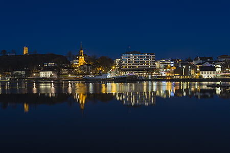 cityscape near body of water during nighttime thumbnail
