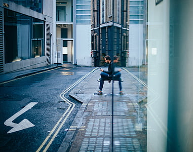 man sitting on gray surface thumbnail