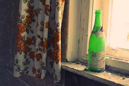 green glass bottle on window thumbnail