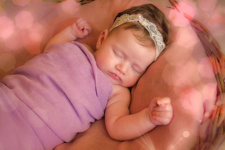 baby lying on brown textile thumbnail