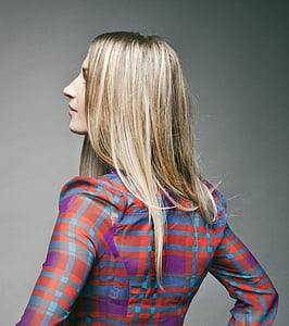 photograph of woman in purple, red, and blue plaid long-sleeved top thumbnail