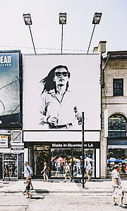 person showing billboard of woman thumbnail