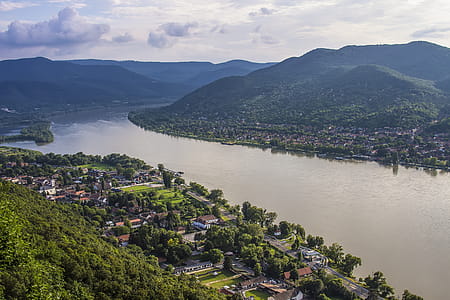 Areal Photo of Building Across Sea and Mountain during Daytime thumbnail