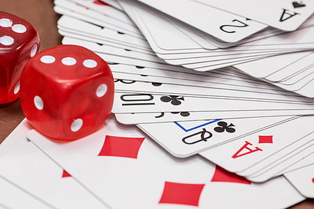 close-up photography of red dice and playing cards thumbnail