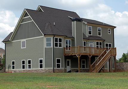 gray and brown wooden house on grass field thumbnail