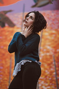 woman in black sweater looking upward thumbnail