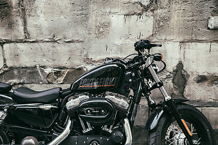 A Harley Davidson motorbike sits by a old wall in Paris, France. Image captured with a Canon 6D thumbnail