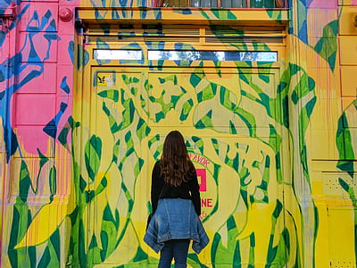 woman standing in front of multicolored door thumbnail