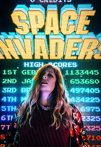 woman standing in front of Space Invader game application thumbnail