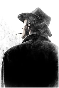 grayscale photography of man with black cowboy hat thumbnail