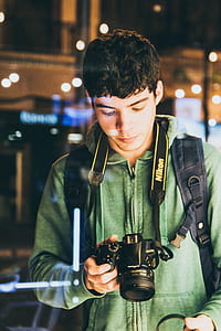 man holding black Nikon DSLR camerea thumbnail