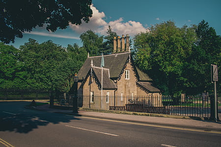 brown concrete house near road thumbnail