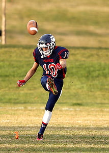 selective focus photography of football player kicking the ball during daytime thumbnail