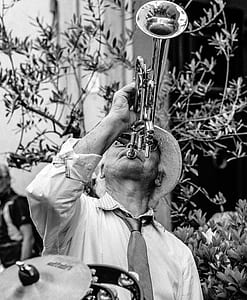 grayscale photo of man playing trumpet thumbnail