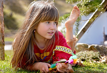 girl wearing red costume laying on grass thumbnail
