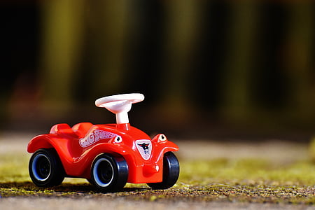 selective-focus photography of red plastic car toy thumbnail