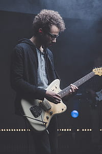 Man Playing Guitar While Looking Downwards thumbnail