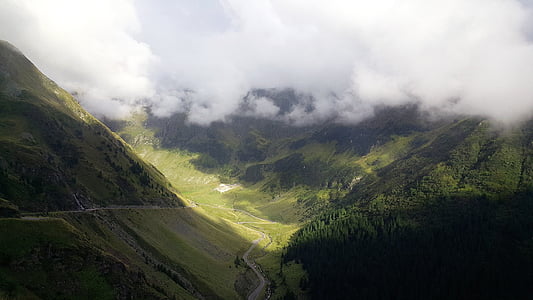 pathway in the middle of grass filled mountains thumbnail