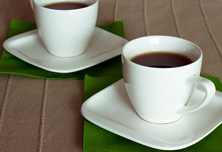 two cups of coffee placed on brown sheet thumbnail