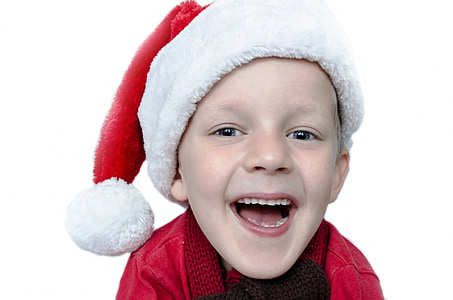 portrait of boy wearing santa hat with broad smile thumbnail