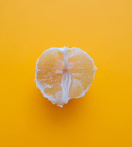 slice on orange fruit on yellow surface thumbnail