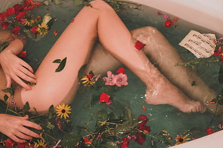 woman lying on bathtub with petaled flower scents thumbnail