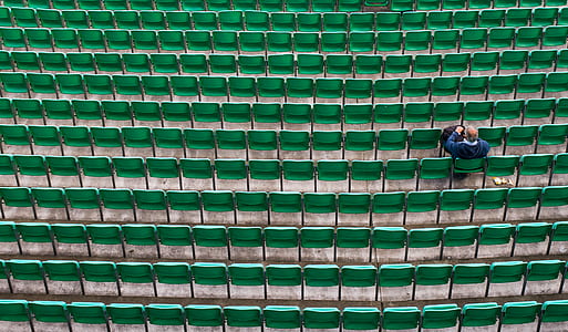 person sitting on green chairs thumbnail