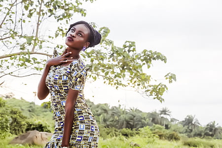 woman wearing green and white short sleeved dress near the tree thumbnail
