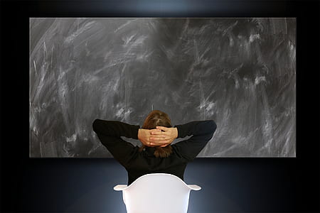 person wearing black long-sleeved top looking at artwork thumbnail