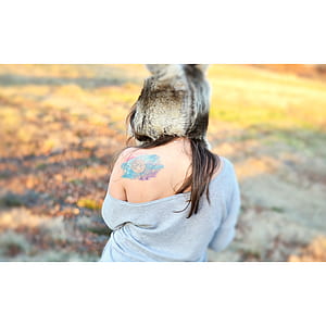 selective focus photography of woman wearing gray cold-shoulder shirt thumbnail