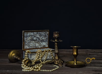 beaded white jewelry near candle stands thumbnail