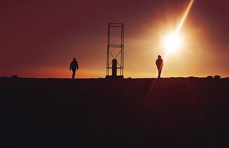 silhouette of two person during sunrise thumbnail