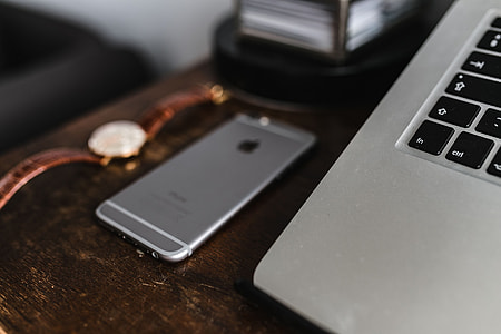 Apple iPhone 6 and Vintage watch on a brown leather wallet thumbnail