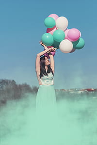 woman holding plastic balloons thumbnail
