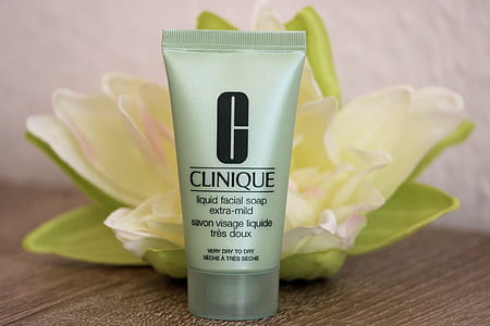 Clinique liquid facial soap soft-tube placed beside yellow cluster petaled flower thumbnail