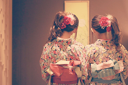two Women in pink, yellow, and teal floral kimono thumbnail