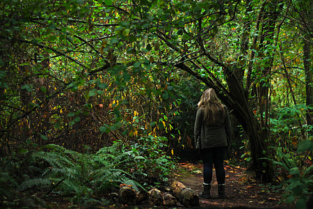 woman standing in the middle of forest thumbnail