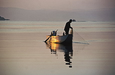 man on boat during daytime thumbnail