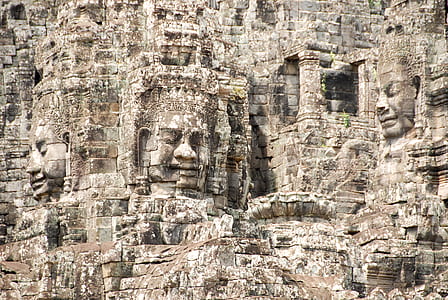 brown concrete wall with faces thumbnail