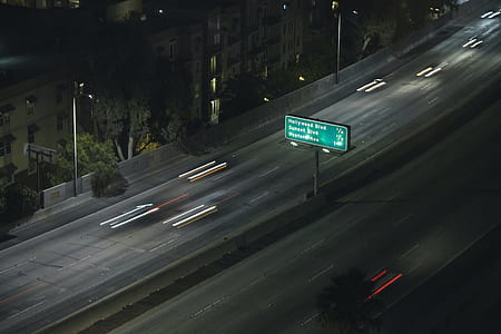 timelapsed photo of a green lighted signage thumbnail