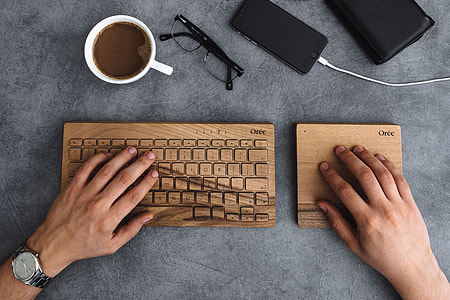 Young man typing on the wooden keyboard thumbnail