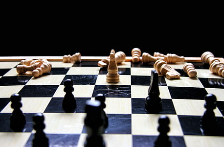 brown and black chess piece and chess board thumbnail