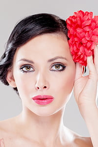 woman with pink lipstick holding red flower thumbnail