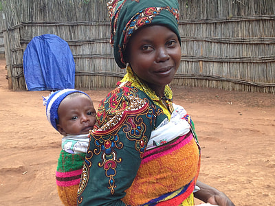 mother carrying her baby on her back thumbnail