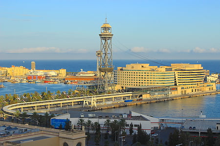 photo of gray tower next to building and body of water thumbnail