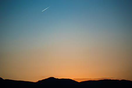 silhouette of mountain under blue sky at sunset thumbnail