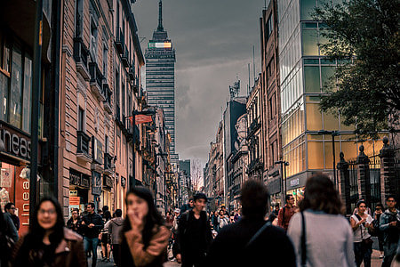 people walking on path surrounded by concrete structures thumbnail